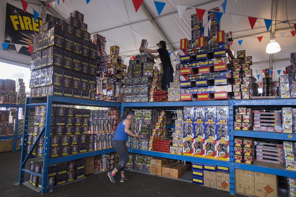 Meagan Williams, left, and Royal Gullickson of TNT Fireworks Warehouse gear up while preparing for customers in Salmon Creek on June 27. New fireworks regulations went into effect this Fourth of July in several Clark County small cities, and fire officials say it was a quiet holiday. Sort of.