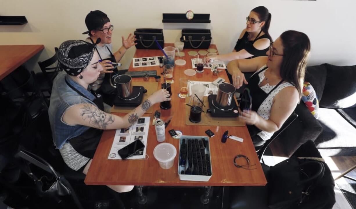 Chelsea McDonald, from left, Alicia Jenkins, Emily Jenkins and Tiffany Ward at WhichCraft, a bar in downtown Vancouver that gives customers the supplies to work on arts and crafts projects.