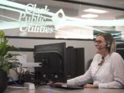 A service representative helps a customer over the phone at Clark Public Utilities in 2019.