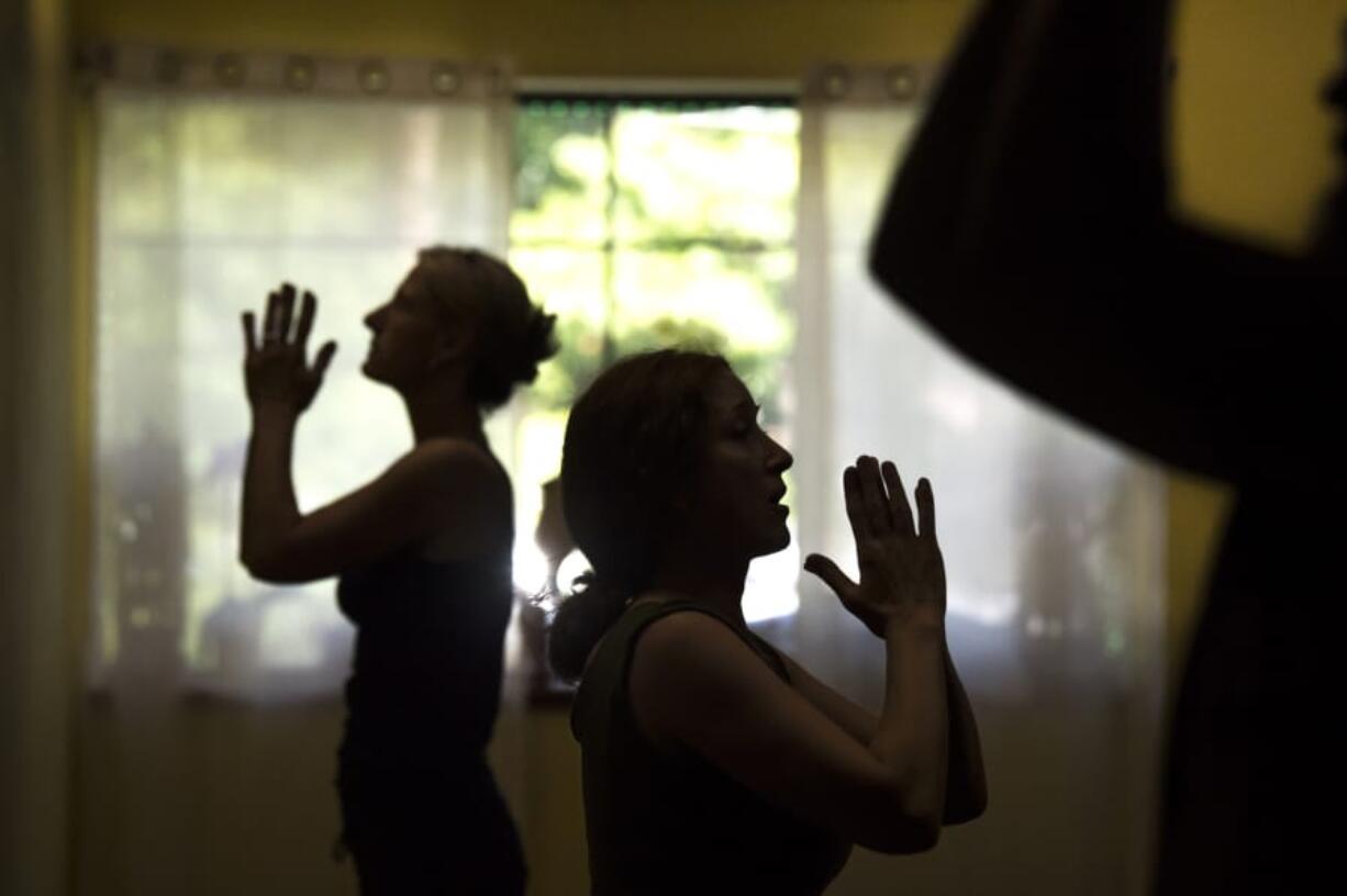 Melonie Nielson, owner of Vancouver Yoga Center, center, leads a Yoga Refinements course last month. “The yoga studio came about out of love and passion for yoga and did not start as a plan to open a yoga business,” she said.