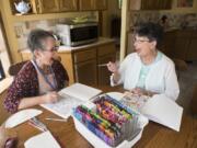 Respite volunteer Rhonda Hurt, left, jokes with hospice patient Marcy Phillips while visiting Phillips’ home in Battle Ground. Hurt visits Phillips for four hours each week to give her husband, Bill, a break, since he is Phillips’ main caretaker.