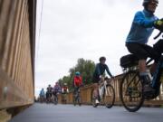 Cyclists cross the elevated boardwalk shortly after Port of Vancouver Commissioner Don Orange cut a ceremonial ribbon on Tuesday.