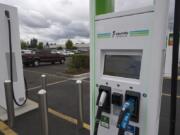 A motorist passes by an electric vehicle charging station at the Walmart store in Hazel Dell. Electrify America and Walmart have installed electric vehicle charging stations at Walmart stores across Washington, including this one in Vancouver. This effort is part of a broader plan to develop a coast-to-coast EV charging network, which would make Walmart one of the largest retail hosts of EV charging stations across the United States.