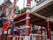 Clarie Graham, 6, of Vancouver climbs up the play structure at Marshall Park in Vancouver.