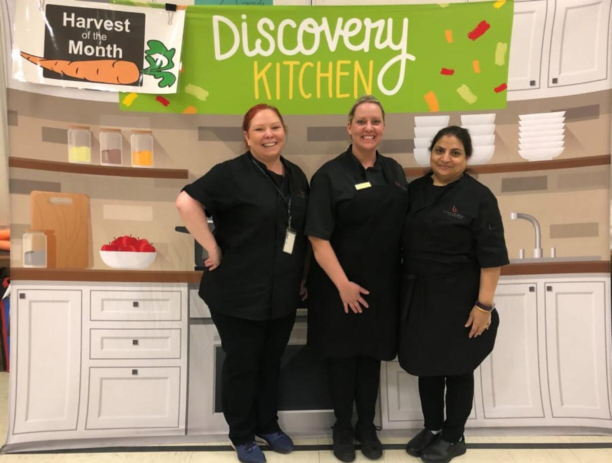 East Vancouver: Chartwells staff, from left, Stacy Struck, Katie Rasmussen and Abida Murtaza brought radishes to Burton Elementary School, which played host to the Harvest of the Month program recently.