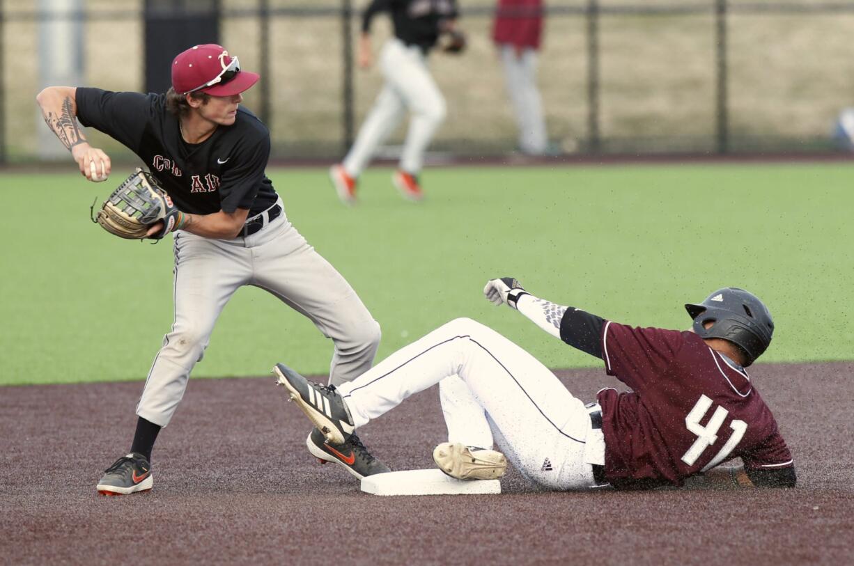 Ridgefield Raptors right fielder Noah Taylor, right, slides to break up a double-play by Corvallis Knights second baseman Jake Harvey, left on Friday. Corvallis won the second game of the series Saturday.