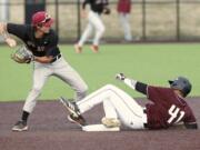 Ridgefield Raptors right fielder Noah Taylor, right, slides to break up a double-play by Corvallis Knights second baseman Jake Harvey, left on Friday. Corvallis won the second game of the series Saturday.