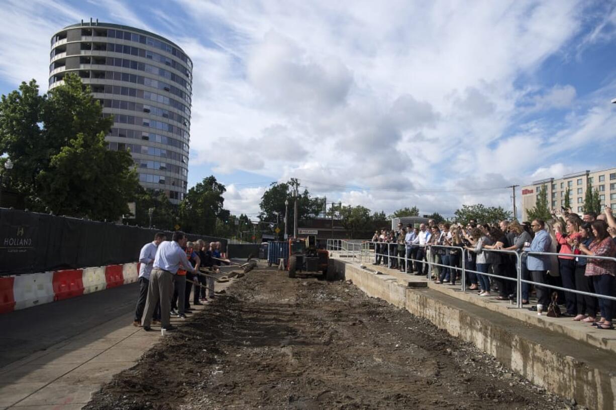 A crowd of onlookers watched Thursday morning as the ceremonial first shovelfuls of dirt were turned over for the fourth tower of the Vancouvercenter.