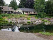 Visitors look out at the water Saturday afternoon at Sandy Swimming Hole Park in Washougal.