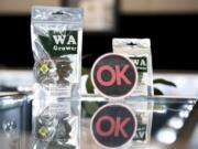 An OK Cannabis sign is displayed with marijuana products at Main Street Marijuana in Vancouver. The industry-led program randomly pulls products from store shelves to test for pesticides and other contaminants.