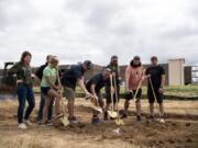 The Trap Door team pours beer out onto the golden shovels during the groundbreaking ceremony at the site of Pioneer Village in Ridgefield. Trap Door was the first tenant to sign a lease at the mixed-use development, which will also include about 300 apartments.