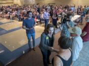 Washington State University Vancouver professor and Democrat Carolyn Long shakes hands with the crowd before announcing her candidacy in front of about 400 supporters at a rally at Clark College on July 8 in her bid for the 3rd Congressional District seat held by Republican Rep. Jaime Herrera Beutler of Battle Ground.