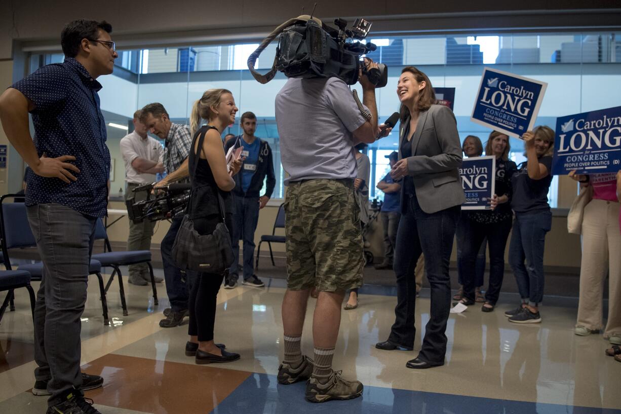 Congressional candidate Carolyn Long gives a television interview following her campaign announcement event at Clark College on Monday night.