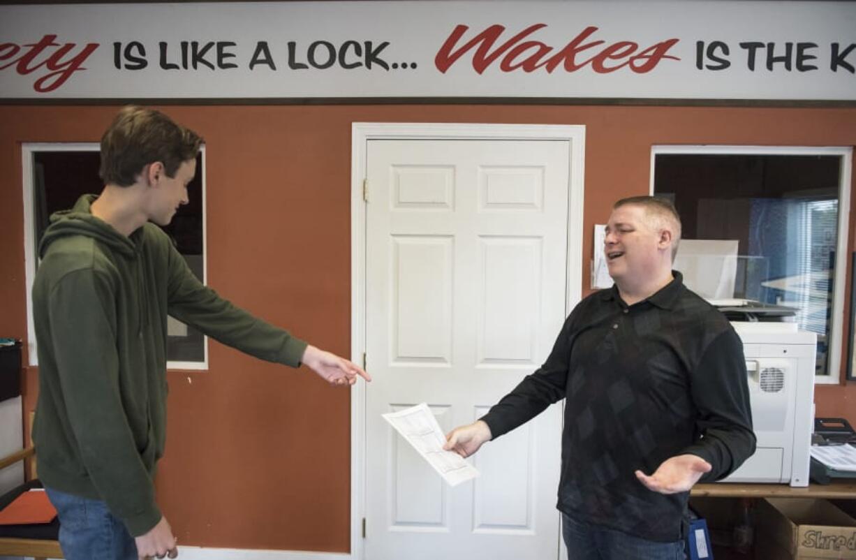 Simon Rommel, 15, left, completes a pre-drive form while Wake’s Driving School instructor Larry Bowman says that the trip is going to increase Rommel’s driving confidence.