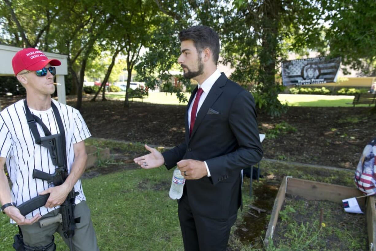 Two candidates for Battle Ground City Council, including Josh VanGelder, right, host a campaign rally Sunday in Battle Ground with Joey Gibson and Patriot Prayer, the right-wing protest group known to brawl in the streets of Portland. Gibson has traveled around the state in recent months pushing for residents and city councils to fight back against controversial gun bill Initiative 1639, which state voters approved last year. VanGelder, seen here talking to a supporter named Sam, who is carrying an AR-15-style rifle, and Shauna Walters have made the issue a major talking point of their respective campaigns.