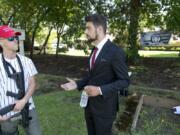 Two candidates for Battle Ground City Council, including Josh VanGelder, right, host a campaign rally Sunday in Battle Ground with Joey Gibson and Patriot Prayer, the right-wing protest group known to brawl in the streets of Portland. Gibson has traveled around the state in recent months pushing for residents and city councils to fight back against controversial gun bill Initiative 1639, which state voters approved last year. VanGelder, seen here talking to a supporter named Sam, who is carrying an AR-15-style rifle, and Shauna Walters have made the issue a major talking point of their respective campaigns.