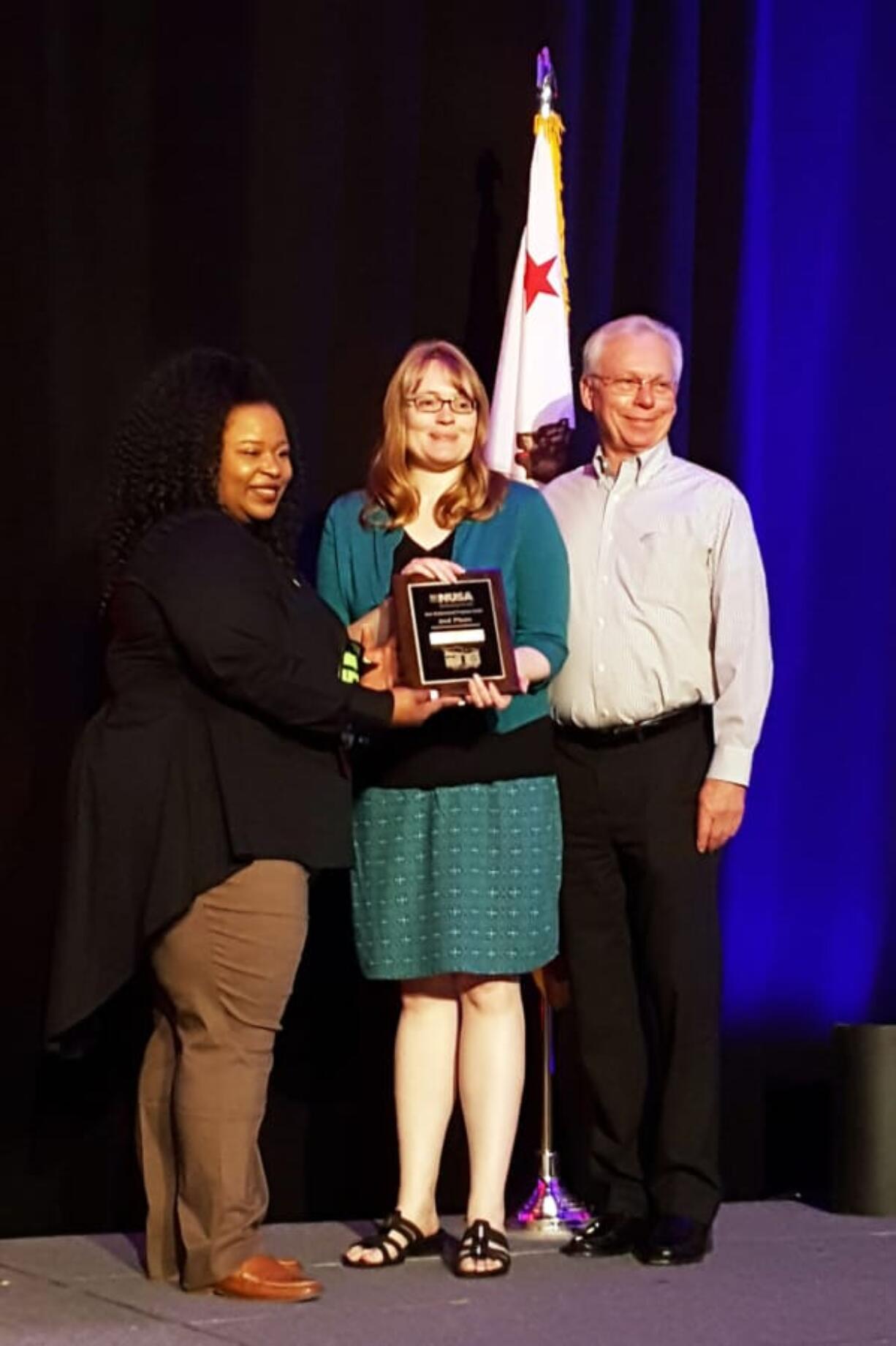 West Vancouver: The city of Vancouver’s Traffic Calming Program recently received a Best Neighborhood Program Award from Neighborhoods USA, a national organization. From left, Neighborhoods USA President Monique Coleman presents the award to Brooke Porter, with Vancouver Public Works, and Ross Montgomery, Neighborhood Traffic Safety Alliance chair.