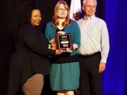 West Vancouver: The city of Vancouver’s Traffic Calming Program recently received a Best Neighborhood Program Award from Neighborhoods USA, a national organization. From left, Neighborhoods USA President Monique Coleman presents the award to Brooke Porter, with Vancouver Public Works, and Ross Montgomery, Neighborhood Traffic Safety Alliance chair.