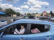 Kathy Decker, a candidate for Vancouver Public Schools Board of Directors Position 4, studies her campaign material in the parking lot of Grocery Outlet before campaigning at the Fourth Plain Community Market. Decker resigned her position as a kindergarten teacher at Peter S. Ogden Elementary School to run for school board, saying her experience as a teacher will help her frame policy and direction for Clark County’s second-largest school district. She’s one of several other teachers running for political office this campaign cycle.