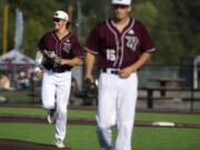 The Raptors' Michael Hicks (31) and Eli Shubert (16) run off the field during the game against the Cowlitz Black Bears at the Ridgefield Outdoor Recreation Complex on Friday night, July 12, 2019.