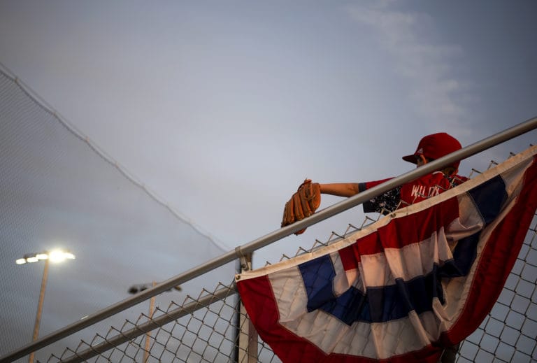 Dylan Wilcox of Vancouver, 9, watches the game between the Ridgefield Raptors and the Cowlitz Black Bears at the Ridgefield Outdoor Recreation Complex on Friday night, July 12, 2019.