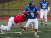 East All Stars’ Trent Hemann (6) attempts to get past West All Stars’ Carter Morse (13) during the first quarter of the Freedom Bowl Classic at McKenzie Stadium, Saturday, July 13.