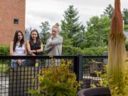 LEAD OPTION: Soon-to-be seniors, Shaniah Chapman, left, Mariah Chapman, middle, and Morgan Beaty, check out a flower affectionately named Titan VanCoug outside the Science and Engineering Building at Washington State University Vancouver on Wednesday. Visitors can check out the plant as it nears its blooming cycle.