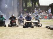 Competitors prepare to start a race Sunday afternoon at the annual lawn mower races at the Amboy Territorial Days celebration.