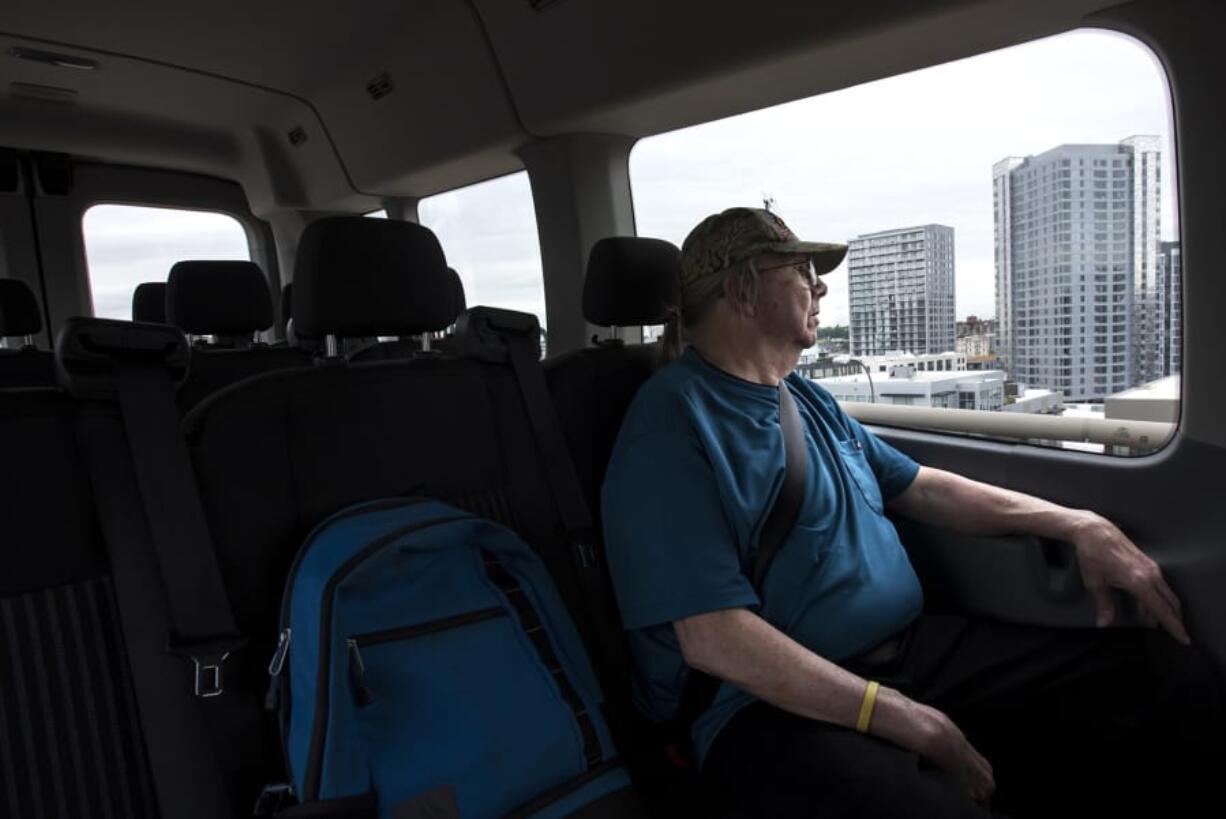 Army Veteran Darrell Macauley, 71, watches the Portland skyline pass from the seat of a Disabled American Veterans transport van to the Portland Veterans Affairs Medical Center for an eye appointment on Wednesday morning. There is a driver shortage for DAV, which impacts veterans’ ability to make medical appointments.