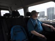 Army Veteran Darrell Macauley, 71, watches the Portland skyline pass from the seat of a Disabled American Veterans transport van to the Portland Veterans Affairs Medical Center for an eye appointment on Wednesday morning. There is a driver shortage for DAV, which impacts veterans’ ability to make medical appointments.