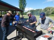 Fruit Valley: Members of the Cascade Park Kiwanis Club cook at the club’s annual barbecue for foster kids.