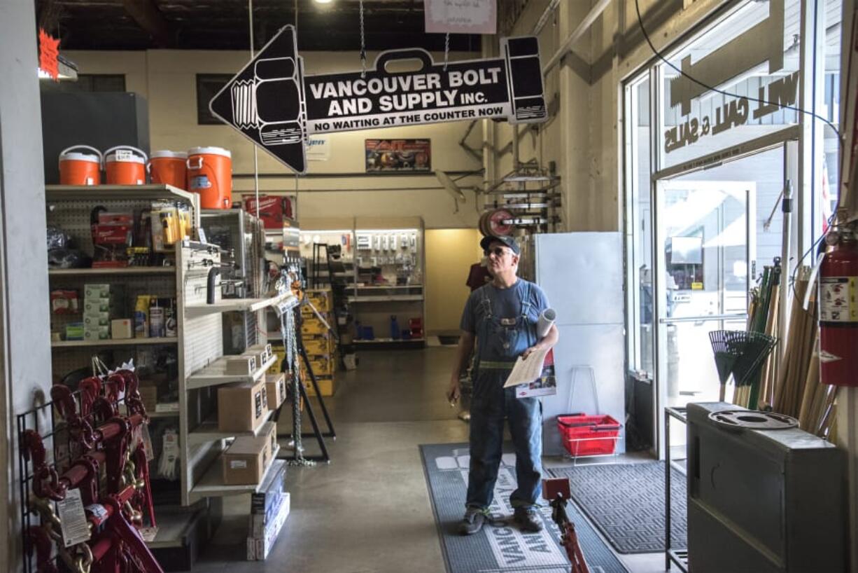 Randal Bernhardt, a longshoreman at the Port of Vancouver and a customer at Vancouver Bolt & Supply for 30 years, looks through the store’s merchandise at the firm’s 40th anniversary sale.