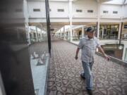 Carl Lingenfelter, a World War II veteran who will turn 100 on Monday, completes a lap of Vancouver Mall during his daily walk through the mall, which unlocks its doors for walkers long before stores open to shoppers.