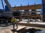 Western Wood construction worker J.P. Castellaw works on the McLoughlin Middle School construction site in Vancouver on Monday.