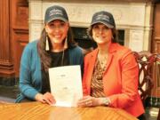 Rep. Jaime Herrera Beutler, left, with Rep. Lucille Roybal-Allard, D-Calif., and a copy of the Midwives for Maximizing Optimal Maternity Services Act.