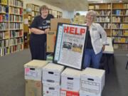 Edgewood Park: Clark County Genealogical Society volunteer librarians Jodi Helton Siewert, left, and Marcia Grubb stand with some of the 13 boxes full of genealogical publications destined for the Paradise Genealogical Society. After the Paradise society’s library burned down in the 2018 wildfire, local genealogical organizations, including the Clark County one, chipped in to send materials so the Paradise group could start building back up their library.