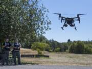 Detective Todd Young, left, and Sgt. Jason Granneman demonstrate one of the drones they use while working in the field at the Clark County Sheriff’s Office’s West Precinct.