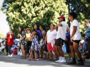 Attendees enjoy live music Sunday at the Four Days of Aloha in the Pacific Northwest festival at Esther Short Park.