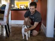 Reid Syverson pets his cat Jack on Thursday at their home in Vancouver. Jack was taken from their home seven weeks ago and was reunited with Syverson and his wife Nora on Wednesday. Reid Syverson describes Jack as their therapy cat. “We’re over the moon having this guy back and safe again,” he said.