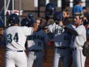 The Bells congratulate Derek Marshall (34) after he hit a home run during Tuesday nightÕs game at the Ridgefield Outdoor Recreation Complex on July 30, 2019.