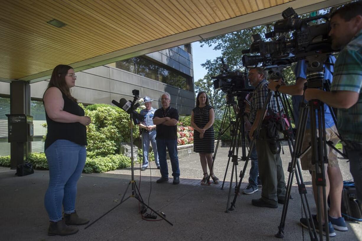 Jessyca Sweeten, left, speaks with members of the media during a Monday press conference at Washington State Patrol headquarters in Vancouver. Sweeten’s car was struck by a bullet the night of July 23 while she was driving east on state Highway 14, and she suffered minor injuries from shattered glass.