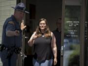 Trooper Will Finn, left, holds the door for Jessyca Sweeten of Vancouver as she prepares to speak to members of the media Monday afternoon at Washington State Patrol headquarters.