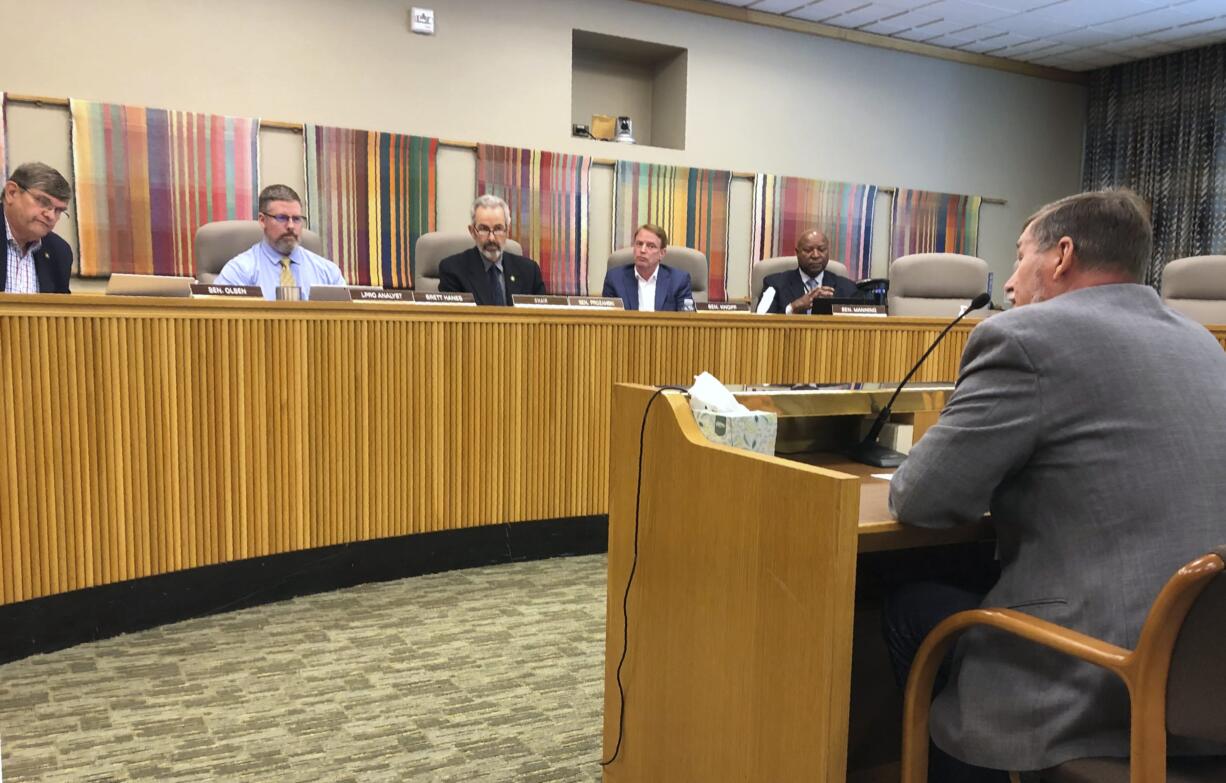 State Sen. Brian Boquist reads a statement on Monday, July 8, 2019, to the Senate special committee on conduct in Salem, Ore. An independent investigator told the Oregon Senate committee Monday that Boquist's threats against state police and the Senate president created an unsafe work environment and suggested he be at least temporarily banned from the Capitol.