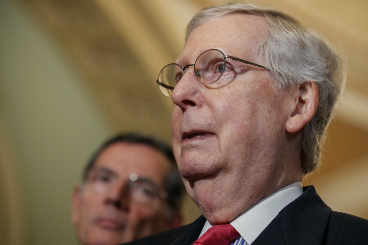 Senate Majority Leader Mitch McConnell of Ky., right, next to Sen. John Barrasso, R-Wyo., speaks to the media after a weekly policy luncheon, Tuesday, July 16, 2019, in Washington. "Everybody ought to tone down their rhetoric," said McConnell.