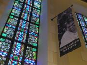 FILE - In this Feb. 12, 2019 file photo, a banner hangs by a stained glass window in the sanctuary at Glide Memorial United Methodist Church in San Francisco. Most Americans don’t typically reach out to religious leaders for guidance, according to a poll from The Associated Press-NORC Center for Public Affairs Research. The poll shows the lack of personal connection with ministers even includes people who identify with a religion, though it’s less prevalent among those most engaged with their faith.