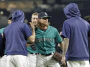 Seattle Mariners starting pitcher Mike Leake, center, is greeted by teammates after he threw a one-hitter against the Los Angeles Angels in a baseball game Friday, July 19, 2019, in Seattle. The Mariners won 10-0. (AP Photo/Ted S.