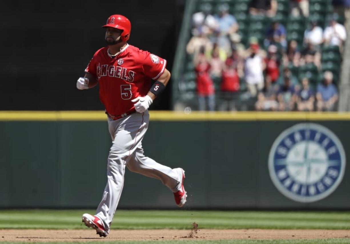 Los Angeles Angels' Albert Pujols rounds the bases on a solo home run against the Seattle Mariners in the second inning of a baseball game Sunday, July 21, 2019, in Seattle.