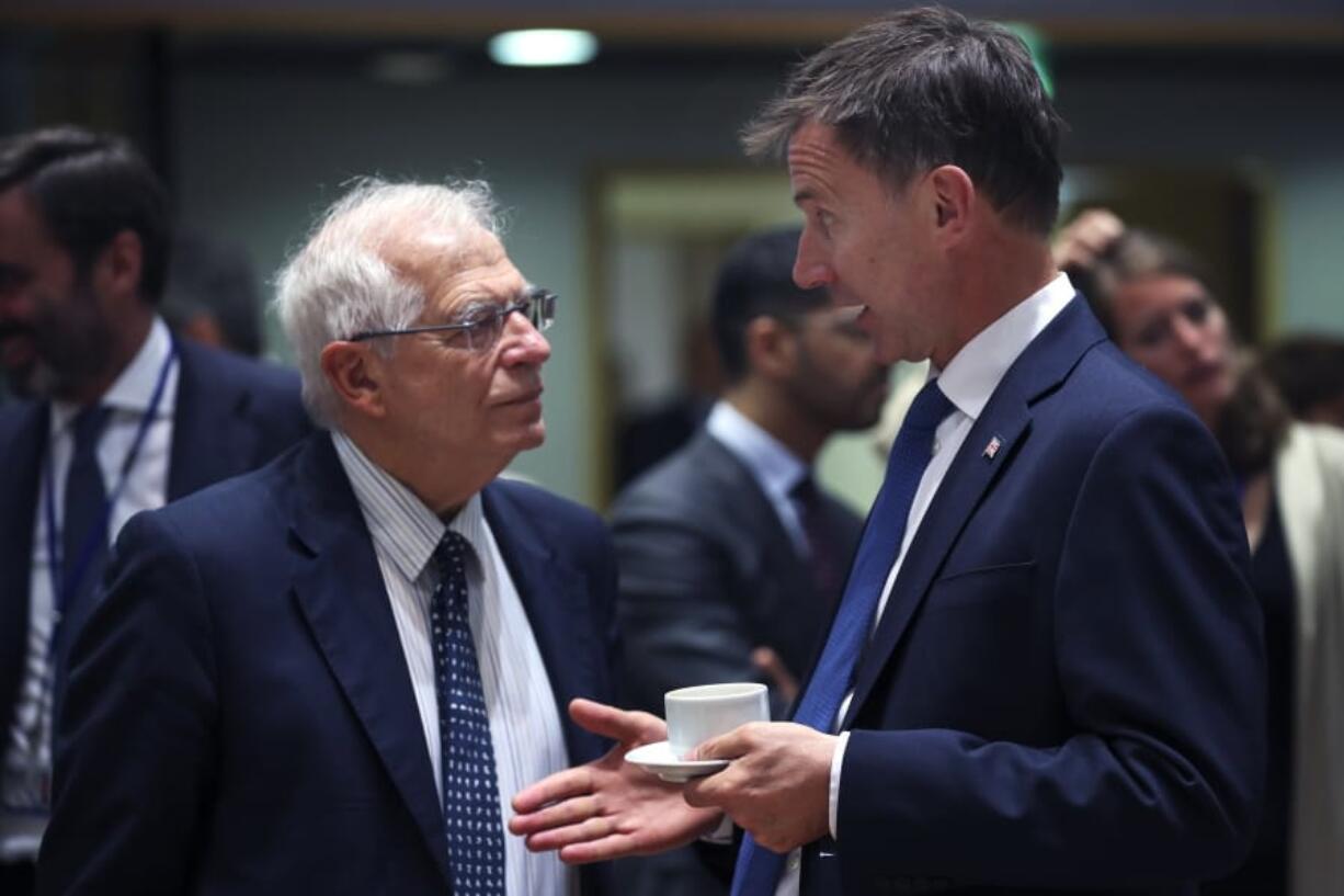 Britain’s Foreign Secretary Jeremy Hunt, right, talks to his Spanish counterpart Josep Borrell during a European Foreign Affairs meeting at the European Council headquarters in Brussels, Monday, July 15, 2019. European Union nations were looking to deescalate tensions in the Persian Gulf area on Monday and call on Iran to stick to the 2015 nuclear deal, despite the pullout of the United States from the accord and the re-imposition of U.S. sanctions on Tehran.