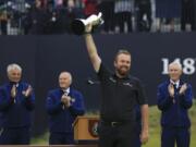 Ireland’s Shane Lowry smiles as he holds the Claret Jug trophy aloft after being presented with it for winning the British Open Golf Championships at Royal Portrush in Northern Ireland, Sunday, July 21, 2019.(AP Photo/Jon Super)