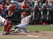 St. Louis Cardinals’ Harrison Bader (48) scores ahead of the throw to Seattle Mariners catcher Austin Nola during the seventh inning of a baseball game Thursday, July 4, 2019, in Seattle.